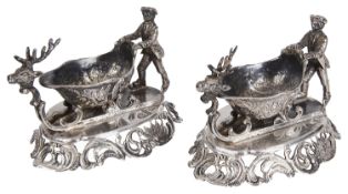 An unusual pair of Continental white metal figural sleigh salts