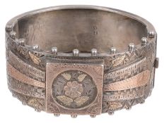 A Victorian silver and gold overlay hinged bangle