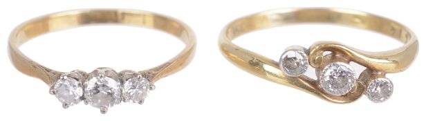 A delicate three stone diamond set scroll ring