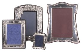 A collection of four contemporary silver photo frames