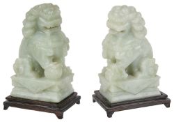 A pair of Chinese green hardstone carved Buddhistic lions, mid 20th century