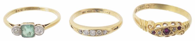 An Edwardian three stone emerald and diamond ring and two other rings
