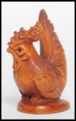A Chinese carved wooden netsuke in the form of a c