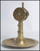 An unusual 20th century brass cigar cutter in the