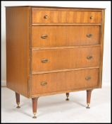 A vintage 20th century teak veneered chest of draw