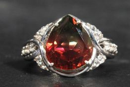 A sterling silver dress ring having a faceted pear