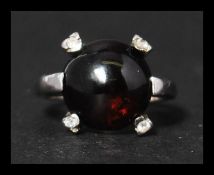 A hallmarked 9ct white gold, garnet and white ston