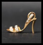 A hallmarked 18ct gold and diamond charm in the fo
