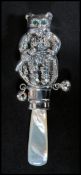 A sterling silver babies rattle in the form of a b