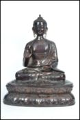A large bronze statue of a Buddha modelled in the