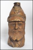 An unusual carved / pulp wood beer bottle in  the