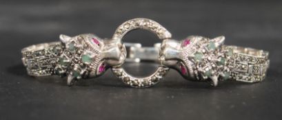 A sterling silver bracelet in the form of two pant