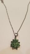 A 9ct white gold ladies necklace and emerald garne