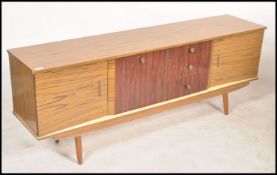 A vintage mid century sideboard raised on tapering
