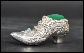 A sterling silver pin cushion in the form of a sho