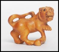 A Chinese carved netsuke in the form of a temple l