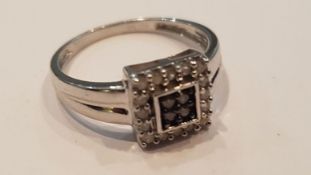 A silver ladies pave set diamond ring. The silver