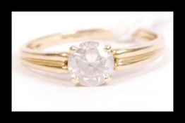 A hallmarked 14ct gold and CZ solitaire ring being set with a single round cut CZ. Hallmarked