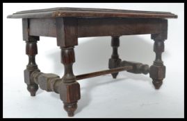 A 19th century Apprentice piece oak refectory dining table being raised on block and turned legs