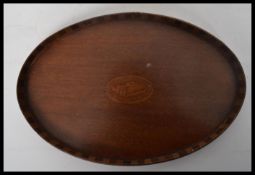 A 19th century Victorian small mahogany tray having an inlaid shell cartouche with raised