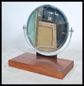 A 1930's Art Deco chrome dressing mirror. The chrome framed roundel mirror set over chrome arched