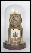 Gustav Becker - A perpetual brass anniversary clock having a glass dome and a wooden socle plinth