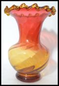 A large mid 20th century studio art glass vase of bulbous form having a fading cranberry to orange