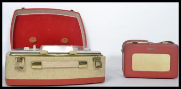 A vintage portable reel to reel tape player together with a vintage Roberts radio.