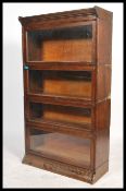 An early 20th century stacking Lawyers oak bookcase cabinet having four glass fronted stacking