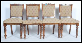 A set of four early 20th century Edwardian dining chairs raised on turned and splayed legs with