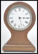 An early 20th century French mahogany inlaid balloon clock. Raised on a pedestal base with bun feet.