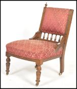 A Victorian mahogany nursing chair raised on turne