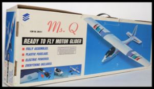 A Ms. Q electric powered remote glider in the original box.