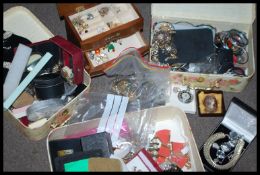 A very large collection of costume jewellery held within four jewellery boxes to include rings ,