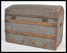 A Victorian wooden bound dome top steamer trunk chest having a dome top with clasps to front