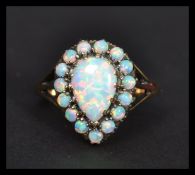 A 9ct gold pear shaped opal cluster ring the central stone having a halo of opals. Weighs 3.3
