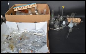 A large collection of vintage 20th century scientific lab glass to include various measures