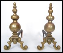 A 19th century Victorian pair of cast brass and iron fire dogs - andirons. Raised on scrolled with