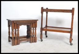 A 1930's Queen Anne revival side table together with an oak nest of tables in the Jacobean revival