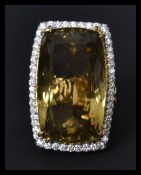 A fantastic and substantial 18ct gold lemon citrine ring having a large central stone of over 50