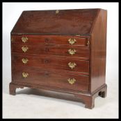 A 19th century Georgian mahogany bureau having a drop front opening to reveal a writing desk area