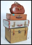 A collection of travel trunks / suitcases dating from the early 20th century to include a steamer
