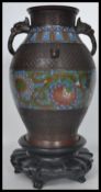 A 19th century Chinese archaistic bronze vase of baluster form. With twin handles modelled as