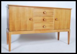 An original Gordon Russell walnut sideboard / dresser. Raised on squared legs with a chest to centre