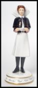 A Michael Sutty ceramic figurine of a nurse limited edition 61/250 model number 2335. Measures 20 cm