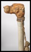 An early 20th century promenade cane with hunting interest having a white painted bamboo cane and