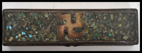 An 18th century Indian brass toothpick box having a malachite inlay lid with swastika to top. The