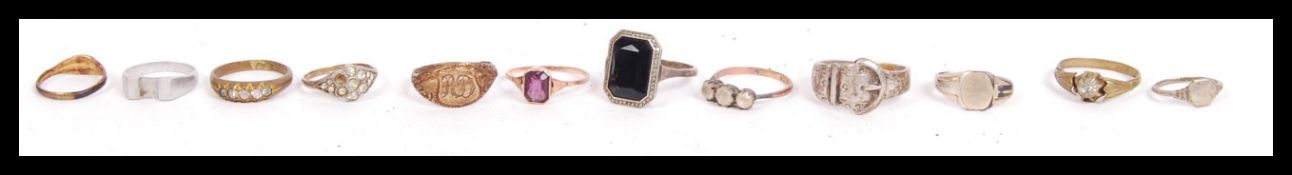 A collection of 9ct gold silver and other rings to include a 9ct gold and purple stone ring,