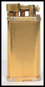 A vintage 20th century English gold plated Dunhill Unique gas lighter having a gilt engine turned