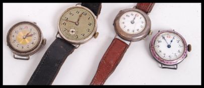 A group of four silver cocktail watches. One having enamel decoration and two set to vintage leather